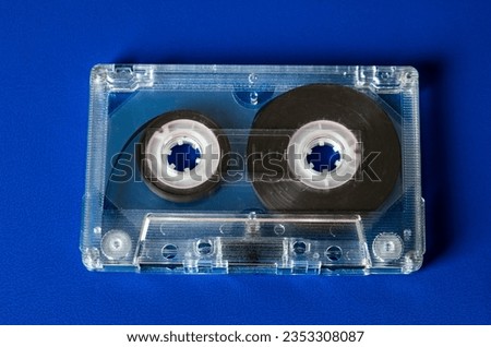Audio Tape Cassette on the Blue Background closeup