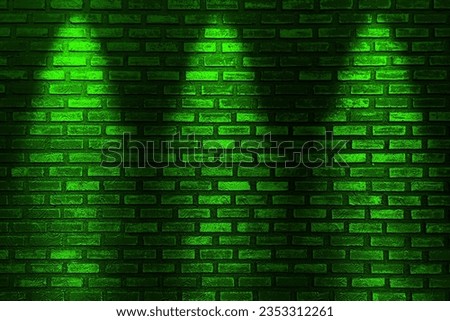 Green neon bulbs on black brick wall. Background texture of empty black wall with green neon light lamp style glow.