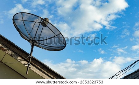 Satellite dish on roof. Satellite dish on sky background. Local satellite dish for house. TV satellite dish on roof