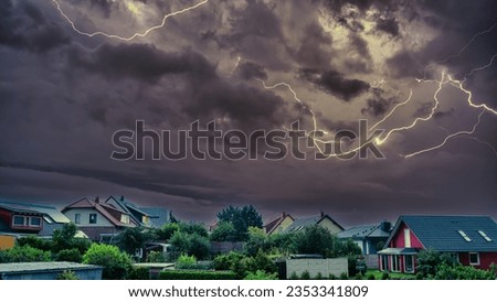 Scary lightning over houses at night during a strong thunderstorm in Deutschland