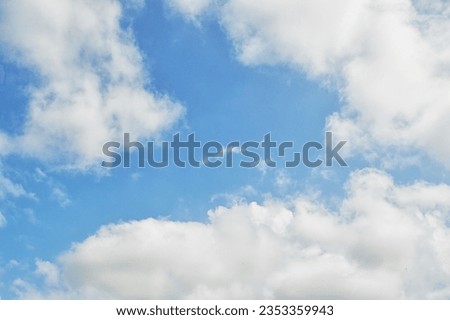 Sky and clouds, low angle view. Cloud with blue sky. White clouds in the blue clean bright sky close-up. Light-headed, dizzy. Dramatic white clouds and sunlight.Nice blue sky with sun beam with cloudy