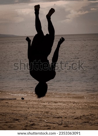 Men do somersaults in the air. Nature and beauty concept. Sunset orange. silhouette at sunset