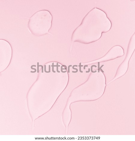 Samples of a transparent gel on a pink background. Texture of liquid cosmetic gel.