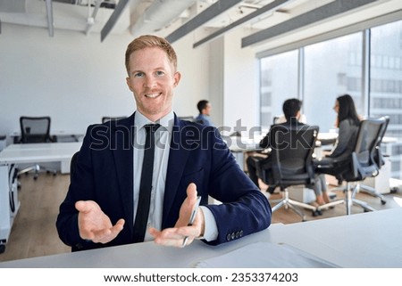 Young confident business man manager talking to web camera having remote video conference call meeting, virtual hybrid interview, giving online webinar training, consulting client in office. Royalty-Free Stock Photo #2353374203