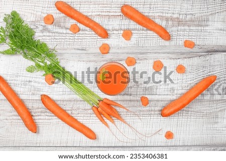 Detox drink in a glass goblet, carrot and parsley slices on a wooden background. Fresh natural carrot smoothie or juice, weight loss concept, fresh fruits and vegetables, cafe advertisement,