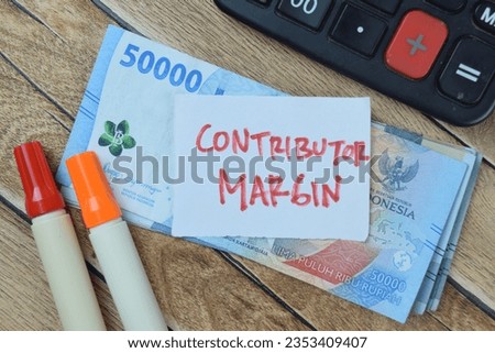 Concept of Contributor Margin write on sticky notes isolated on Wooden Table.