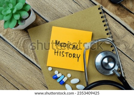 Concept of Medical History write on sticky notes with stethoscope isolated on Wooden Table.