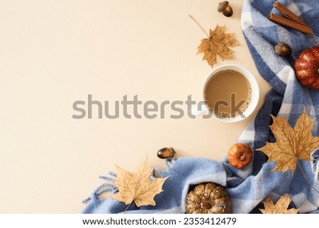Create an autumn-infused environment for your work. Top view photo of cozy plaid, fragrant coffee, acorns, pumpkins, autumn leaves on pastel beige background with promotional slot