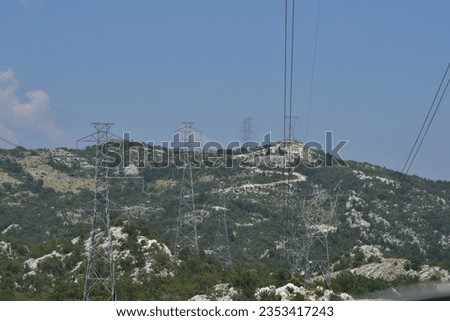 Electricity grid poles in countryside. Electrical supply over high distances.