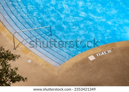 Edge of swimming pool with No Diving warning sign and 3 ft depth marker