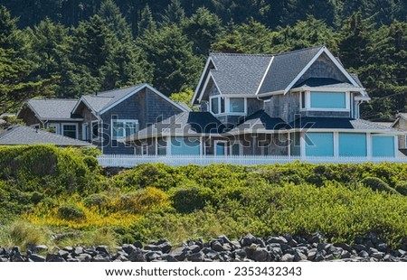 Beautiful wooden house with fence in a forest Environment. Modern designed house exterior in the forest. Cottage house on the hills. Travel photo, nobody