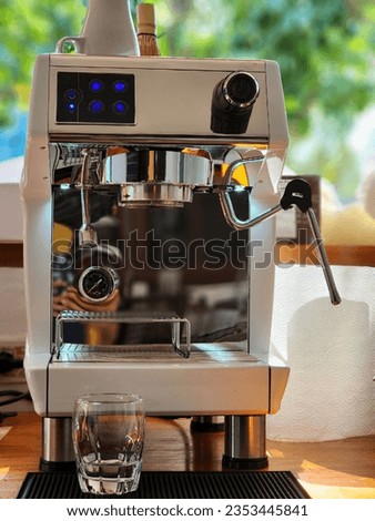 Small coffee shop with white coffee machine.