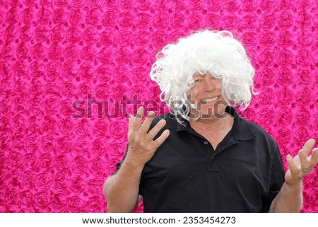 Photo Booth. A man poses and smiles and laughs while having his pictures taken  in a Photo Booth at a Wedding or Party. Photo Booths are Popular for all parties around the world. Photo Booths are Fun.