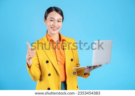 Photo of young Asian businesswoman with colorful suit on background