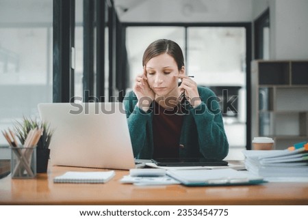 Overworked businesswoman suffering from headache and thinking how to end work.