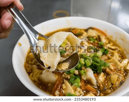 Dumplings in sour and spicy soup