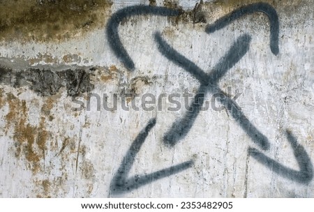 Black letter "X" isolated on old dirty concrete wall background.