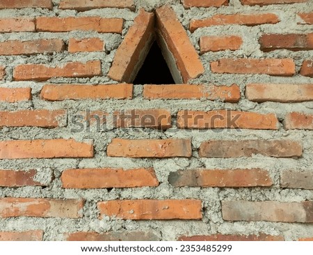 Horizontal photo of brick wall pattern with triangle shape.