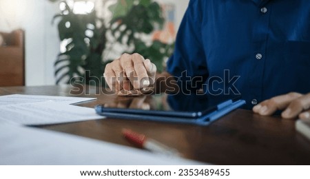 Businessman in casual clothes use digital tablet working on desk. legal expert work part time, professional lawyer meeting online with client and discuss laws or insurance contracts., Close-up view