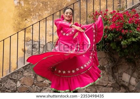 Latin couple of dancers wearing traditional Mexican dress from Guadalajara Jalisco Mexico Latin America, young hispanic woman and man in independence day or cinco de mayo parade or cultural Festival Royalty-Free Stock Photo #2353498435