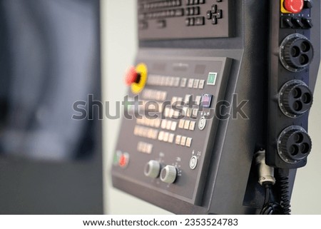 Control panel  and manual handwheel control unit of 5 axis CNC machining center. Selective focus. Royalty-Free Stock Photo #2353524783