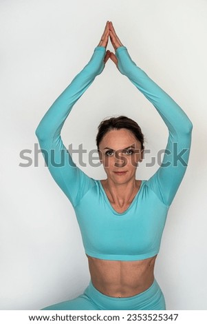 Beautiful sportswoman stretching before training indoors. Sport woman stretch her legs doing exercises in the gym alone. isolated on white background. silhouette of a girl warming up
