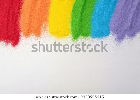 Celebrate LGBT history month with sand flag art. Top view showcases a rainbow flag made from sand on white, inviting an copy space for supportive text Royalty-Free Stock Photo #2353555315