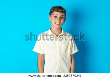 Close up photo of Beautiful kid boy wearing casual shirt toothy smiling