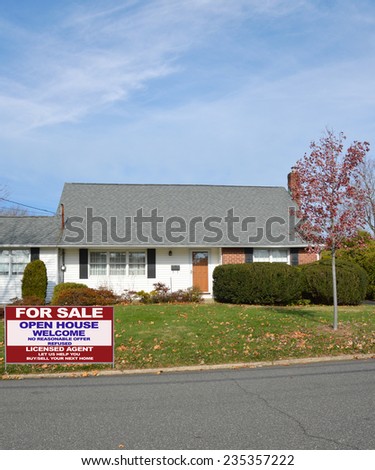 Real Estate for sale open house welcome sign front yard lawn suburban bungalow style home autumn season residential neighborhood blue sky clouds USA