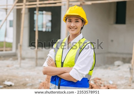 Portrait woman contruction worker smart confident look with engineer safety suit work in construction site Royalty-Free Stock Photo #2353578951