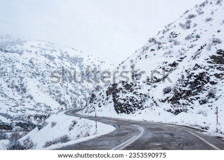 winding road in winter photographed from car