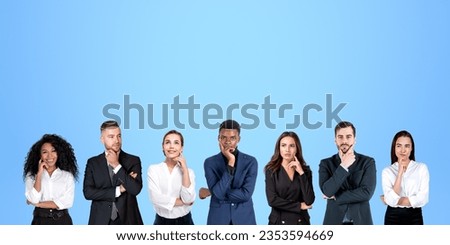 Group portrait of seven pensive diverse business people thinking standing in row over blue background. Concept of brainstorming and teamwork Royalty-Free Stock Photo #2353594669