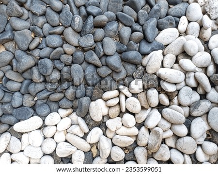 Small naturally polished rock pebbles background and texture