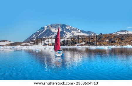 Lne yacht and red sails - Panoramic view of colorful Kulusuk village in East Greenland - Kulusuk, Greenland - Melting of a iceberg and pouring water into the sea