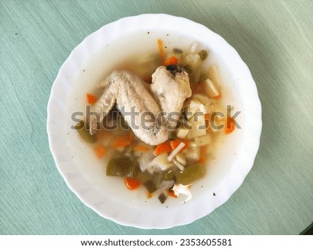 Soup with vegetables and a chicken wings