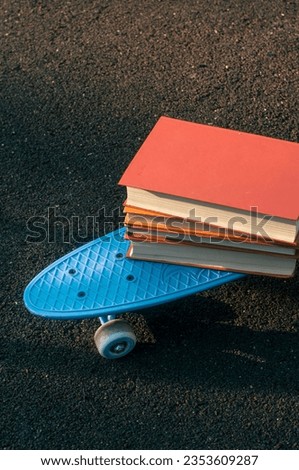 Blue skateboard with books outdoor shot back to school concept learning sunny picture