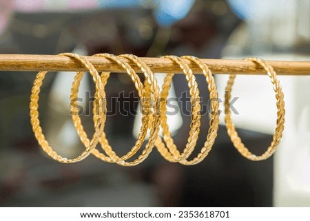 24k (24 carat) Turkish gold twist bracelet lined up at the gold store Royalty-Free Stock Photo #2353618701