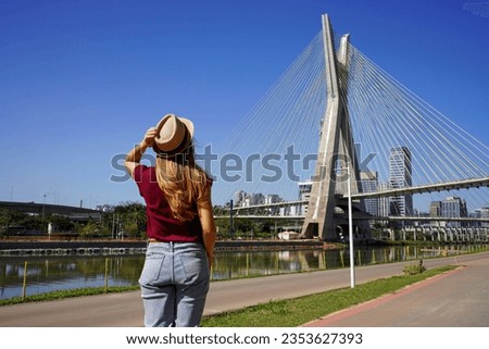 Back view of woman enjoying view of Ponte Estaiada bridge in Sao Paulo, Brazil Royalty-Free Stock Photo #2353627393