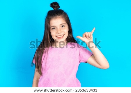 Beautiful kid girl wearing pink T-shirt over blue background showing up number six Liu with fingers gesture in sign Chinese language