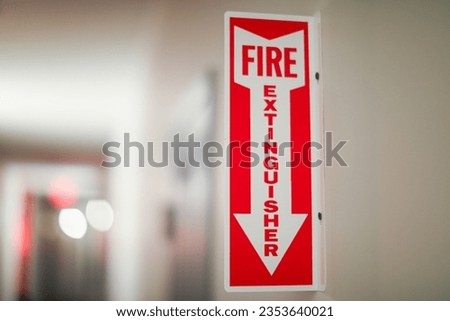 Fire extinguisher and sign depicting safety, urgency, preparedness, red color, prevention, emergency response