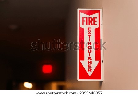 Fire extinguisher and sign depicting safety, urgency, preparedness, red color, prevention, emergency response