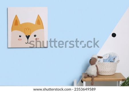Cute picture hanging on color wall in children's room