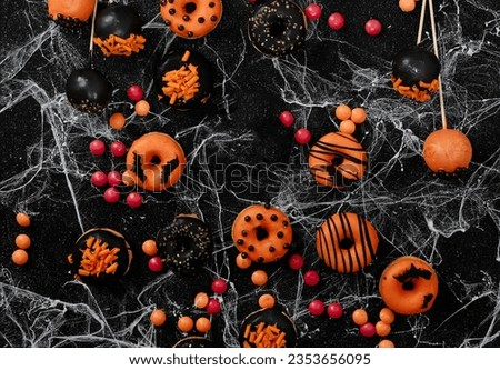 Halloween sweets for Halloween party on black background. top view.