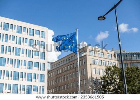 Broken EU flag against blue sky in Brussels