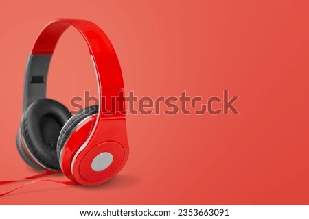 Wireless modern red headphones on background