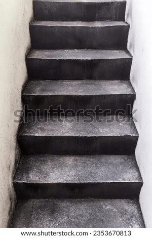 a photography of a black and white photo of a set of stairs, balustraded steps leading up to a white wall in a building.