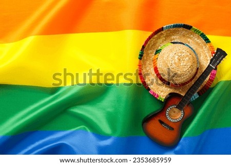 Guitar and sombrero on the background of the lgbt flag.