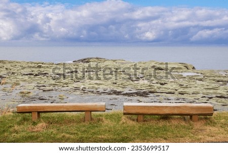 Empty long wooden seat For sitting and watching the rocks and the Sea of Japan. The moment when the clouds are about to rain