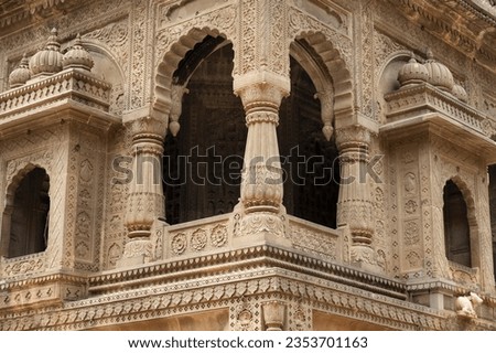Carving details on the outer wall of Shri Ahilyeshwar Mandir, situated in Ahilya Devi Fort complex on the banks of River Narmada, Maheshwar, Madhya Pradesh, India Royalty-Free Stock Photo #2353701163