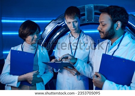 discussion of three scientists at the center of the future Royalty-Free Stock Photo #2353705095